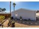 Backyard featuring desert landscaping, gravel, mature palm trees, and a serene outdoor space at 10951 N 91St Ave # 250, Peoria, AZ 85345