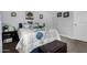 Comfortable bedroom featuring a floral-patterned comforter and a cushioned bench at 10951 N 91St Ave # 250, Peoria, AZ 85345