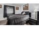 Elegant bedroom featuring dark bedding, decorative artwork and a view of the exterior at 10951 N 91St Ave # 250, Peoria, AZ 85345