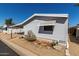 This shows the side view of a charming single-story home with awning-covered window at 10951 N 91St Ave # 250, Peoria, AZ 85345