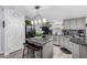 Gray kitchen boasts modern appliances, a stylish island, and elegant backsplash at 10951 N 91St Ave # 250, Peoria, AZ 85345