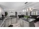 Open-concept kitchen featuring an island with seating and a seamless flow to the living area at 10951 N 91St Ave # 250, Peoria, AZ 85345
