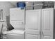 Laundry room with stacked washer/dryer and upper cabinets for storage solutions at 10951 N 91St Ave # 250, Peoria, AZ 85345