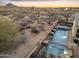 Aerial shot of the luxurious pool, landscaping, and scenic desert surroundings at 11053 E Hedgehog Pl, Scottsdale, AZ 85262