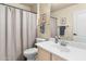 Well-lit bathroom with a vanity, toilet and shower-tub combination at 11053 E Hedgehog Pl, Scottsdale, AZ 85262