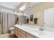 Bright bathroom with a double sink vanity, large mirror, and neutral color palette at 11053 E Hedgehog Pl, Scottsdale, AZ 85262