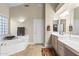 Bathroom featuring a soaking tub with privacy window and a double vanity at 11053 E Hedgehog Pl, Scottsdale, AZ 85262