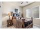 Cozy bedroom featuring a wooden bed frame, a ceiling fan, and a bright window at 11053 E Hedgehog Pl, Scottsdale, AZ 85262