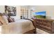 Comfortable bedroom features a rustic dresser and bright outside views at 11053 E Hedgehog Pl, Scottsdale, AZ 85262