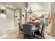 Dining area with a round wood table, chandelier lighting, and views into the kitchen at 11053 E Hedgehog Pl, Scottsdale, AZ 85262