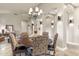Dining area with a round wood table, chandelier lighting, and views into the living room at 11053 E Hedgehog Pl, Scottsdale, AZ 85262