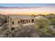 Exterior view of a desert home with a private patio and desert landscape at 11053 E Hedgehog Pl, Scottsdale, AZ 85262