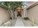 Inviting front entrance with desert landscaping, stone accents and cozy lighting at 11053 E Hedgehog Pl, Scottsdale, AZ 85262