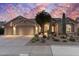 Charming front exterior with desert landscaping, three-car garage and inviting entrance at 11053 E Hedgehog Pl, Scottsdale, AZ 85262
