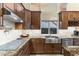 Updated kitchen featuring granite counters, stainless sink and appliances, and tile backsplash at 11053 E Hedgehog Pl, Scottsdale, AZ 85262