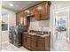Well-equipped laundry room with dark wood cabinets and modern appliances at 11053 E Hedgehog Pl, Scottsdale, AZ 85262
