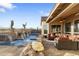 Beautiful backyard featuring a sparkling pool, patio seating, and desert landscaping at 11053 E Hedgehog Pl, Scottsdale, AZ 85262