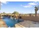Inviting pool featuring cascading waterfalls surrounded by desert flora at 11053 E Hedgehog Pl, Scottsdale, AZ 85262