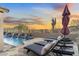 Relaxing poolside scene with comfortable lounge chairs and a scenic desert backdrop at 11053 E Hedgehog Pl, Scottsdale, AZ 85262