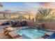 Relaxing spa with waterfall feature and desert views, complemented by an outdoor dining area at 11053 E Hedgehog Pl, Scottsdale, AZ 85262
