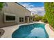Backyard features a covered patio, stone deck, and a sparkling pool, perfect for outdoor entertaining at 1210 E Azure Sea Ln, Gilbert, AZ 85234