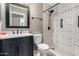 Modern bathroom featuring tile shower with decorative tile, and stylish vanity at 1210 E Azure Sea Ln, Gilbert, AZ 85234