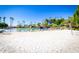 Sandy beach area with volleyball court and lounge chairs, perfect for outdoor activities and relaxation at 1210 E Azure Sea Ln, Gilbert, AZ 85234