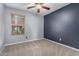 This bedroom features a ceiling fan, and a window looking out to the neighborhood at 1210 E Azure Sea Ln, Gilbert, AZ 85234