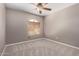 Bright bedroom with neutral walls, carpet, and window with blinds and decorative ceiling fan at 1210 E Azure Sea Ln, Gilbert, AZ 85234