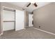 Bedroom with tan walls, neutral carpet, closet, and a ceiling fan at 1210 E Azure Sea Ln, Gilbert, AZ 85234