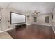 Spacious media room with hardwood floors, projector screen, ceiling fan, and recessed lighting at 1210 E Azure Sea Ln, Gilbert, AZ 85234