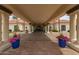 Inviting clubhouse entrance with lush landscaping, planters, and covered walkway at 1210 E Azure Sea Ln, Gilbert, AZ 85234
