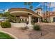 Elegant clubhouse entrance with portico, columns and lush landscaping at 1210 E Azure Sea Ln, Gilbert, AZ 85234
