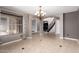 Elegant foyer showcasing tile flooring, a staircase with black railings, and a chandelier illuminating the welcoming space at 1210 E Azure Sea Ln, Gilbert, AZ 85234