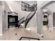 Grand foyer with curved staircase, neutral walls, decorative tile flooring, and arched doorways at 1210 E Azure Sea Ln, Gilbert, AZ 85234
