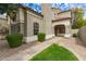 Charming home exterior featuring a well-manicured lawn, stone accents, and a welcoming entrance at 1210 E Azure Sea Ln, Gilbert, AZ 85234
