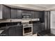 Close-up of kitchen showcasing dark cabinetry, granite countertops, stainless steel appliances and a functional layout at 1210 E Azure Sea Ln, Gilbert, AZ 85234