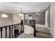 Open carpeted landing with decorative light fixture and dark wood railing at 1210 E Azure Sea Ln, Gilbert, AZ 85234