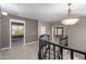 Open carpeted landing featuring decorative light fixture and dark wood railing at 1210 E Azure Sea Ln, Gilbert, AZ 85234