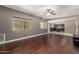 Open-concept living room with wood floors, a ceiling fan, and easy access to the kitchen provides the perfect space for gatherings at 1210 E Azure Sea Ln, Gilbert, AZ 85234