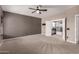 Expansive bedroom with carpet floors offers versatile space, ideal for relaxation, and personal customization at 1210 E Azure Sea Ln, Gilbert, AZ 85234