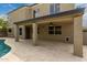 Covered patio overlooking the pool and grassy area at 1210 E Azure Sea Ln, Gilbert, AZ 85234