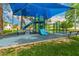 Shaded blue and green playground with multiple slides and climbing features on a blue surface at 1210 E Azure Sea Ln, Gilbert, AZ 85234
