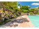 Stunning pool area with cascading waterfalls and lush landscaping at 1210 E Azure Sea Ln, Gilbert, AZ 85234