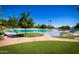 Expansive lagoon style pool with palm trees and grassy areas, ideal for lounging and outdoor activities at 1210 E Azure Sea Ln, Gilbert, AZ 85234