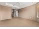 Spacious bedroom with neutral carpeting, large windows, and open doorway at 14000 N 94Th St # 3147, Scottsdale, AZ 85260