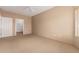Spacious bedroom with carpet, a window with wood blinds, and a door to a walk-in closet at 14000 N 94Th St # 3147, Scottsdale, AZ 85260