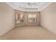 Neutral bedroom featuring carpet, a ceiling fan, tray ceiling, and two windows with wood blinds at 14000 N 94Th St # 3147, Scottsdale, AZ 85260