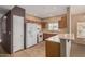 Well-lit kitchen with breakfast bar, tile floors, and modern white appliances at 14000 N 94Th St # 3147, Scottsdale, AZ 85260