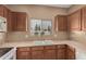 Kitchen with double sink, tile backsplash, and wood cabinets at 14000 N 94Th St # 3147, Scottsdale, AZ 85260